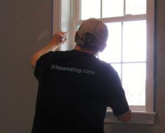 owner/operator painting a window.