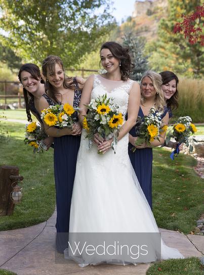 bride with fun bridesmaids holding sunflower bouquet