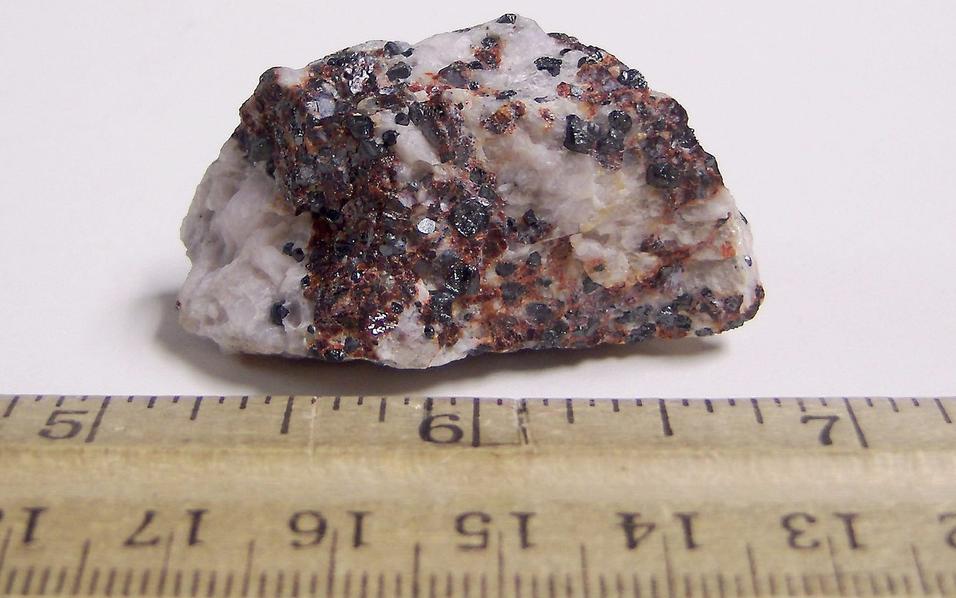 Black Franklinite, red Zincite, white Hydrozincite, green fluorescent Willemite, white Calcite - Sterling Mine, Sterling Hill, Ogdensburg, Franklin Mining District, Sussex County, New Jersey, USA