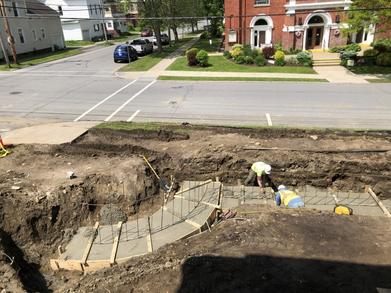 Poured concrete in forms with construction workers