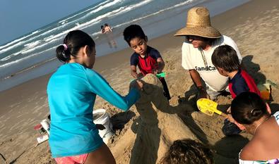 Jose and friends create a sandy octopus