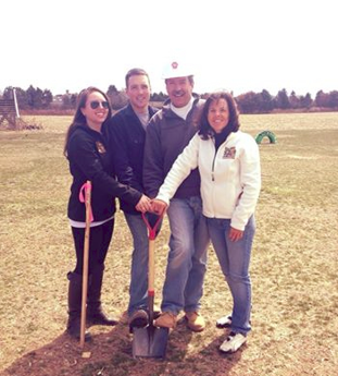 A Photo of Hank, his wife, son and daughter the day they broke ground on the market at Hank's PumpkinTown