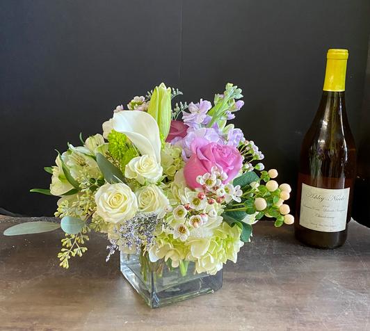 Hand-tied bridal bouquet with white ranunculus, brunia, billy balls, succulents, and other elements