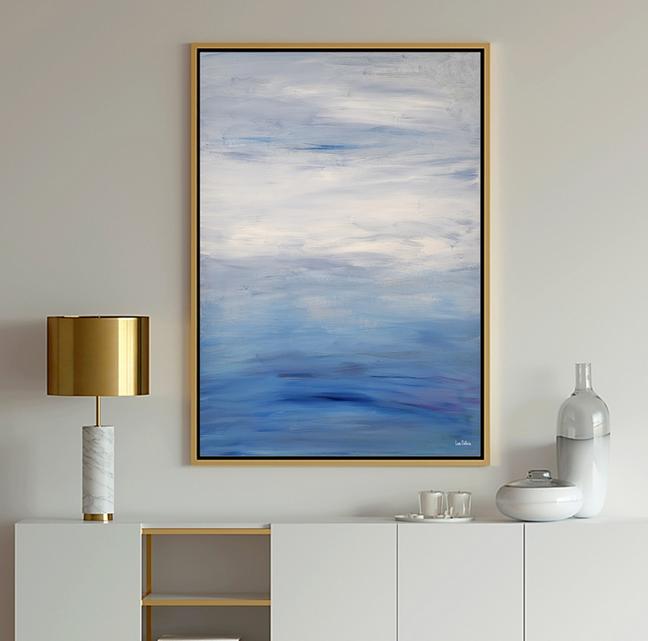 Blue Art ocean seascape in light blue, white which shows calm waves in the water and clouds in the sky.