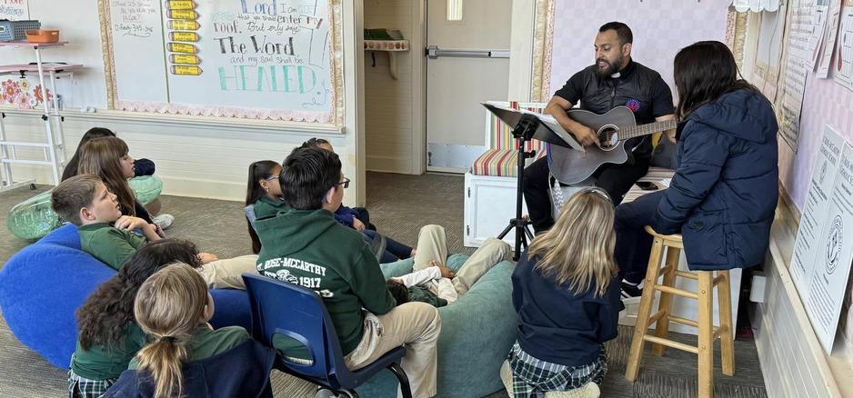 Fr. Cesar Singing with St. Rose-McCarthy Students