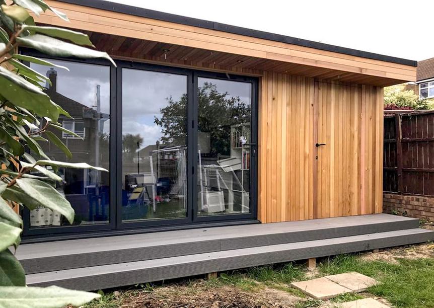 Modern cedar clad garden room with bifold doors and large deck, in Langdon Hills, Essex built by Robertson Garden Rooms